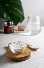 selective focus. Collagen powder in a glass container. light background. copyspace. Extra protein intake. Natural beauty and Health supplement for skin, bones, joints and intestines