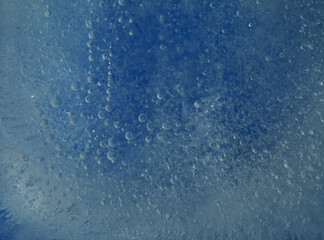 Ice texture with small round air bubbles trapped inside 
