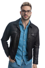 confident young casual guy with glasses holding hand in pocket