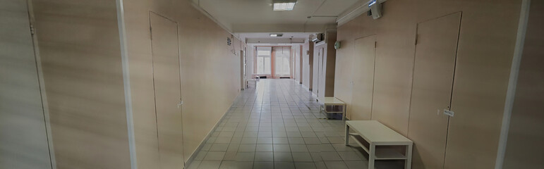 Tiled floor and window in an empty hallway of a small hospital