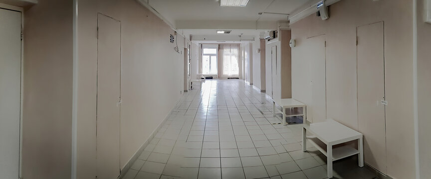 Tiled floor and window in an empty hallway of a small hospital