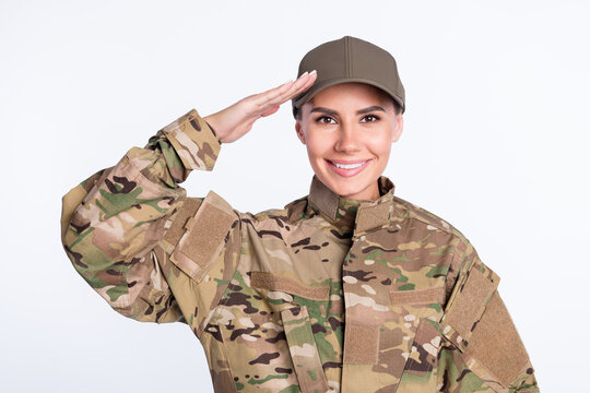 Photo of young woman happy smile soldier army officer show hand salute sign isolated over white color background