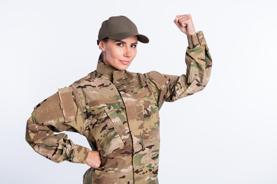 Photo of young woman confident soldier officer show hand biceps power strong isolated over white color background