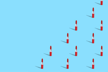 . Women's lipstick on a blue background. A vibrant modern pattern with hard shadows. Blank for the designer.