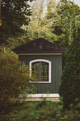 Wooden shed among trees - 417316674