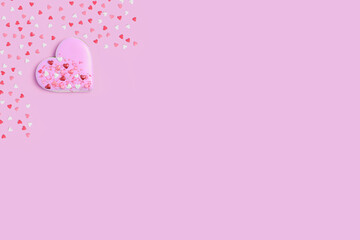 Fototapeta na wymiar . Heart shaped cookies or gingerbread on pink pastel background with blank space for text. The concept before the wedding day, Valentine's day, women's day. Blank for a greeting card.
