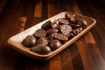 Mini halves of crunchy easter eggs on a wooden basket on a wooden table.