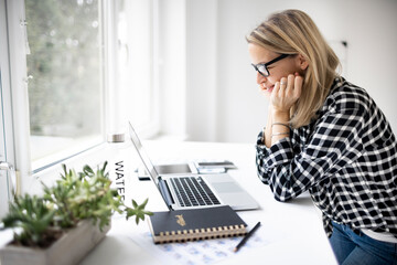 Businesswoman working at a standing desk in a modern office space
