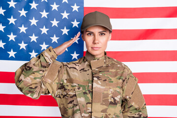 Portrait of calm serious lady arm head saluting greetings look focused camera isolated on usa national flag
