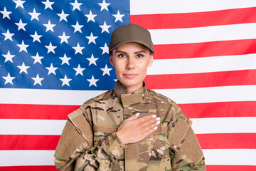 Portrait of attractive positive lady arm palm on heart look camera isolated on usa national flag background