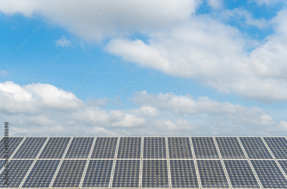 Wall mural solar panels under a sunny sky