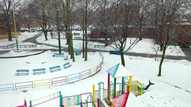 Aerial Pan View of an Inner-City Park During a Snow Storm - Part 1