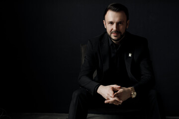 Portrait of a handsome man in black suit indoor