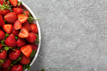 Ripe delicious strawberries on a white plate, top view