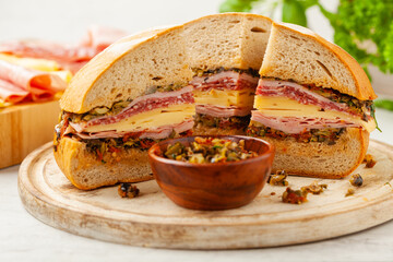 Muffuletta. Sandwich with cheese, ham and olive paste. A traditional recipe in New Orleans.