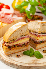 Muffuletta. Sandwich with cheese, ham and olive paste. A traditional recipe in New Orleans.