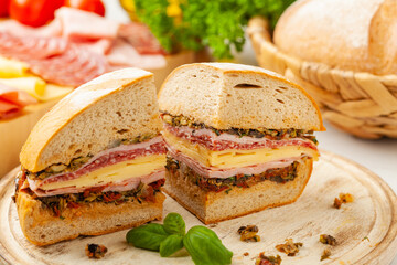 Muffuletta. Sandwich with cheese, ham and olive paste. A traditional recipe in New Orleans.