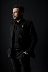Portrait of a handsome man in black suit indoor