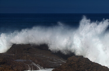 Gran Canaria, north coast, area around Punta Sardina cape, powerful foamy ocean waves breaking along the shore
