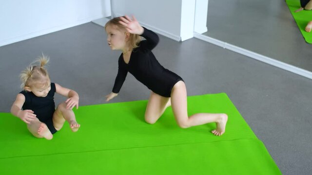 two little girls indulge in yoga class