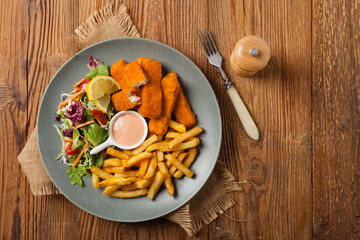 Fish sticks with fries and salad.
