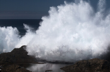 Gran Canaria, north coast, area around Punta Sardina cape, powerful foamy ocean waves breaking along the shore
