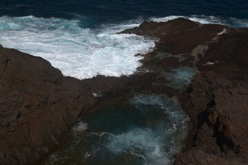 Fototapeta premium Gran Canaria, north coast, area around Punta Sardina cape, powerful foamy ocean waves breaking along the shore 