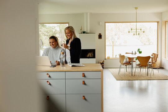 Two women working with laptop at home