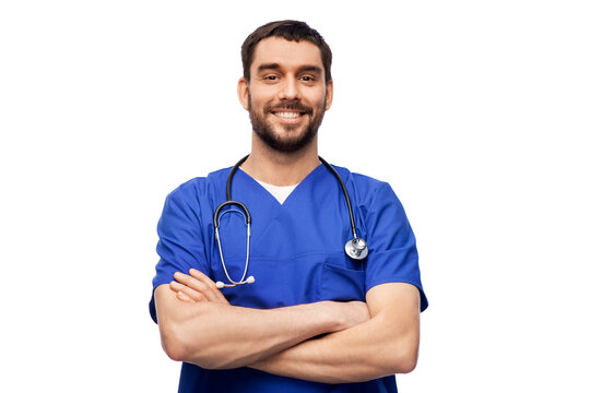 Healthcare, Profession And Medicine Concept - Happy Smiling Doctor Or Male Nurse In Blue Uniform With Stethoscope Over White Background