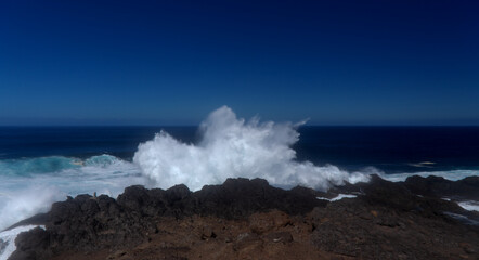 Gran Canaria, north coast, area around Punta Sardina cape, powerful foamy ocean waves breaking along the shore
