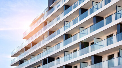Apartment residential house and home facade architecture and outdoor facilities. Blue sky on the background. Sunlight in sunrise.