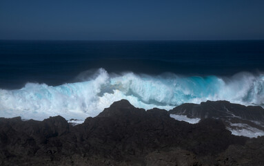 Gran Canaria, north coast, area around Punta Sardina cape, powerful foamy ocean waves breaking along the shore

