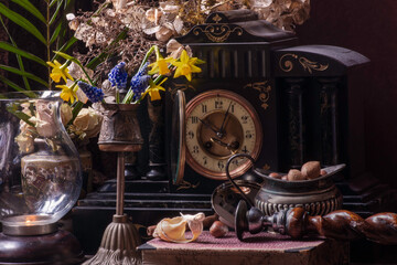 Antique clock with spring flowers.