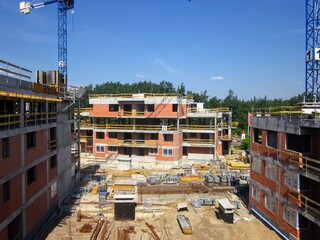 Residental houses under construction. Building construction site with crane against blue sky