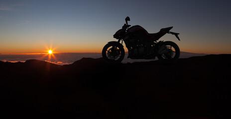 Motorbike parking with sunset background. Biker ride motorcycle. Silhouette of motobike. Trip and...