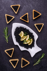 Tartlets with black caviar