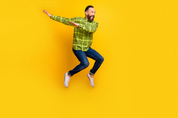 Fototapeta na wymiar Full length photo of mature man happy positive smile jump up dance dab hip-hop isolated over yellow color background