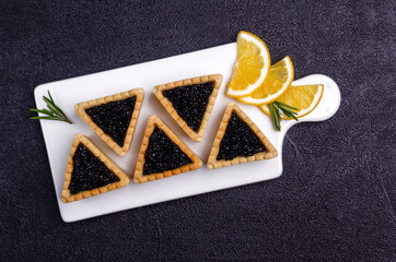 Tartlets with black caviar