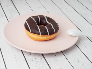 Delicious glazed donuts on white wooden table. Space for text