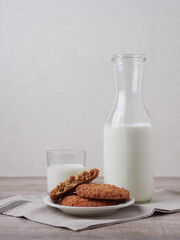 Homemade shortbread kamut cookies with glass of milk on light background
