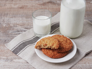 Homemade shortbread kamut cookies with glass of milk on light background
