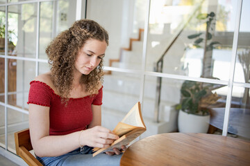 Beautiful girl.  smiling woman reading a book at home Study Concept reading book