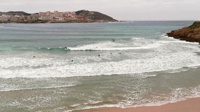 Surf school students practicing from Orz&aacute;n Beach in La Coru&ntilde;a