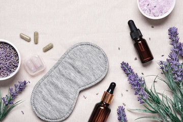 Sleep mask and lavender products for healthy sleep on textile background. Healthy night sleep...
