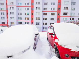 Parking car on lots in houses neighborhood while snow falling