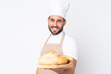 Male baker holding a table with several breads isolated on white background