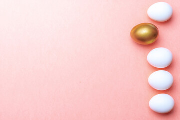 Easter message. Golden, white colour egg on pastel pink background in Happy Easter decoration. Foil minimalist egg design, modern top view template.