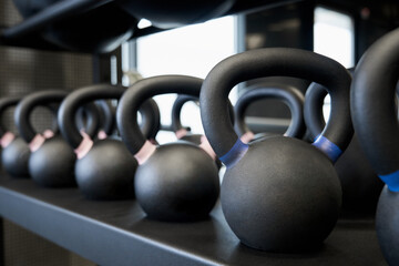 Black kettlebells in modern gym.