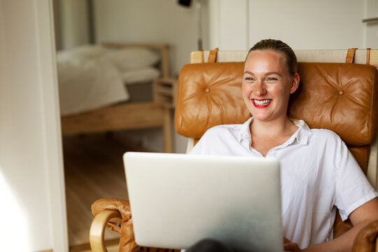 Happy woman using laptop
