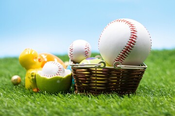 Baseball with Easter eggs are on green grass for Easter Holiday